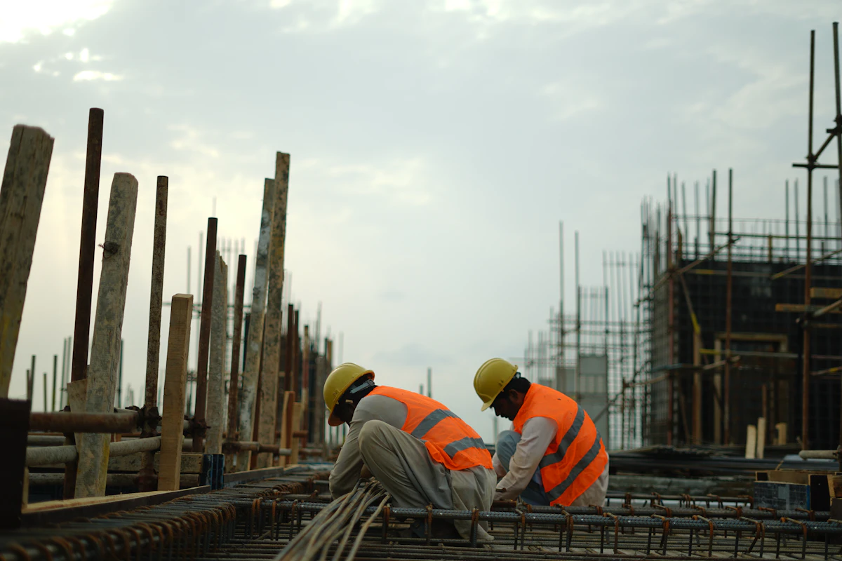 Two construction operatives working on a reinforced concrete structure