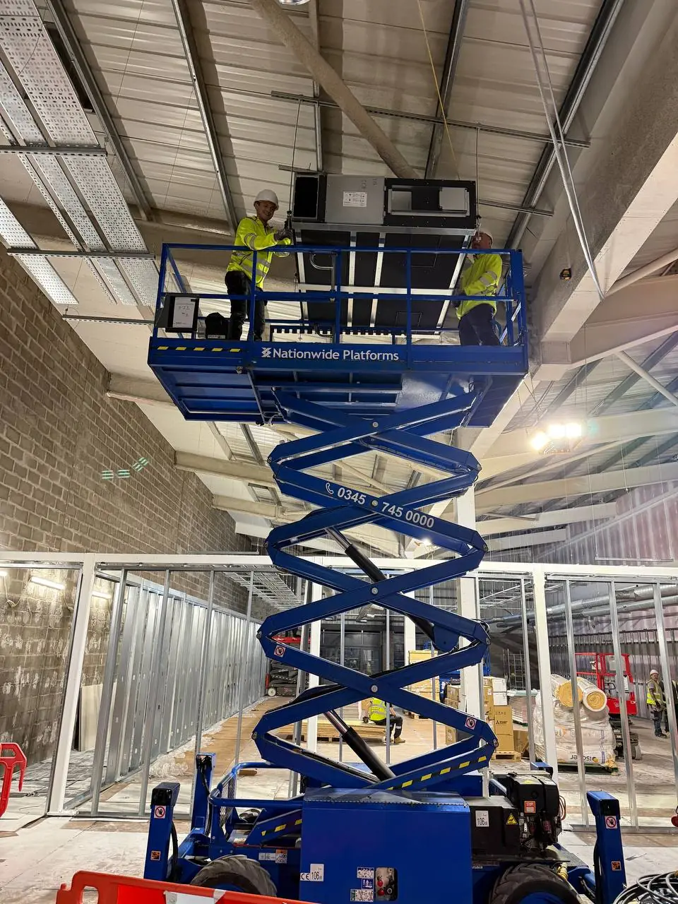 Ventilation installation work in an active construction environment